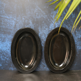 Black oval bowl standing with wall