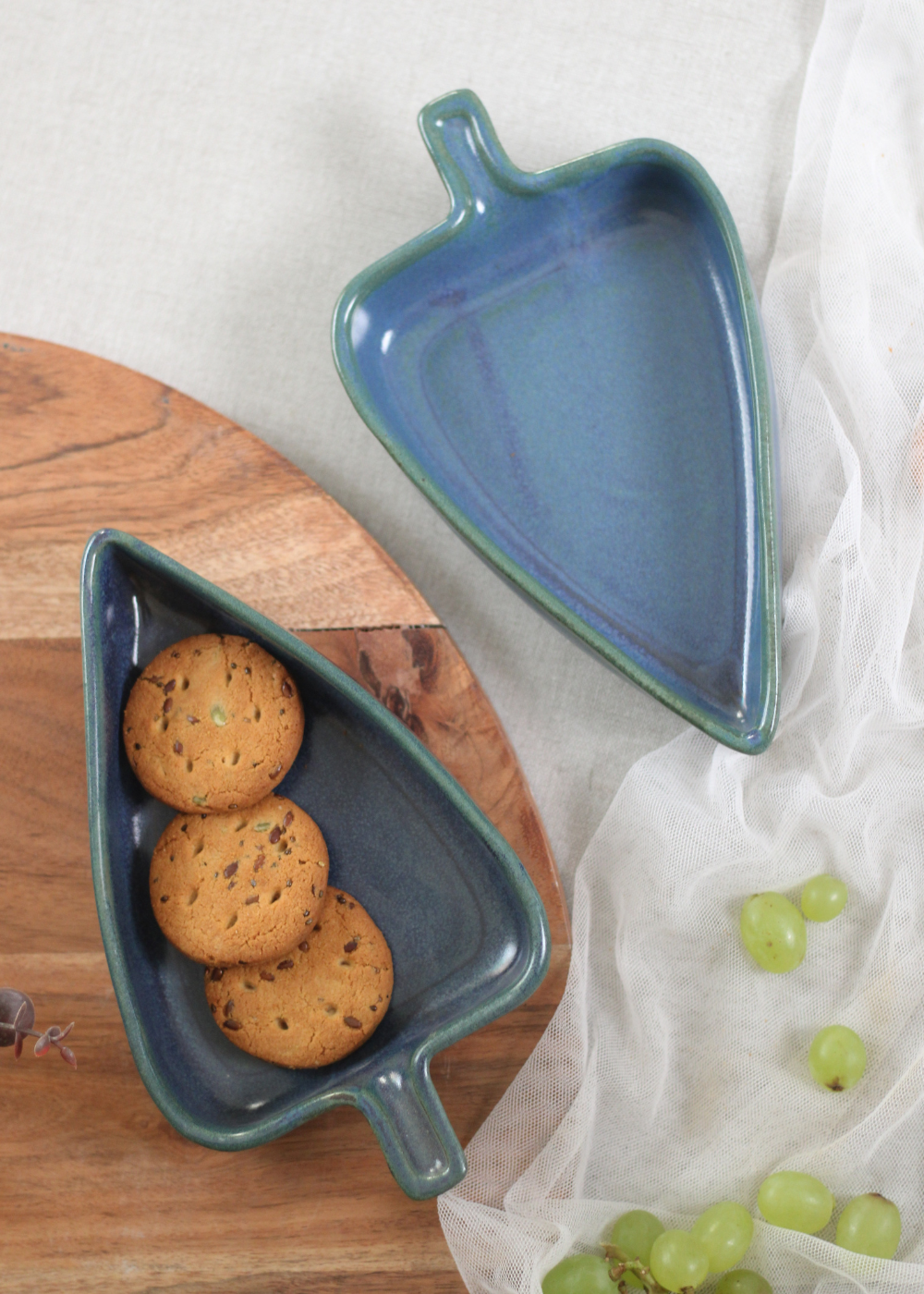 Handmade ceramic blue leaf bowls with biscuits