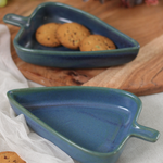 Two blue leaf bowls with biscuits