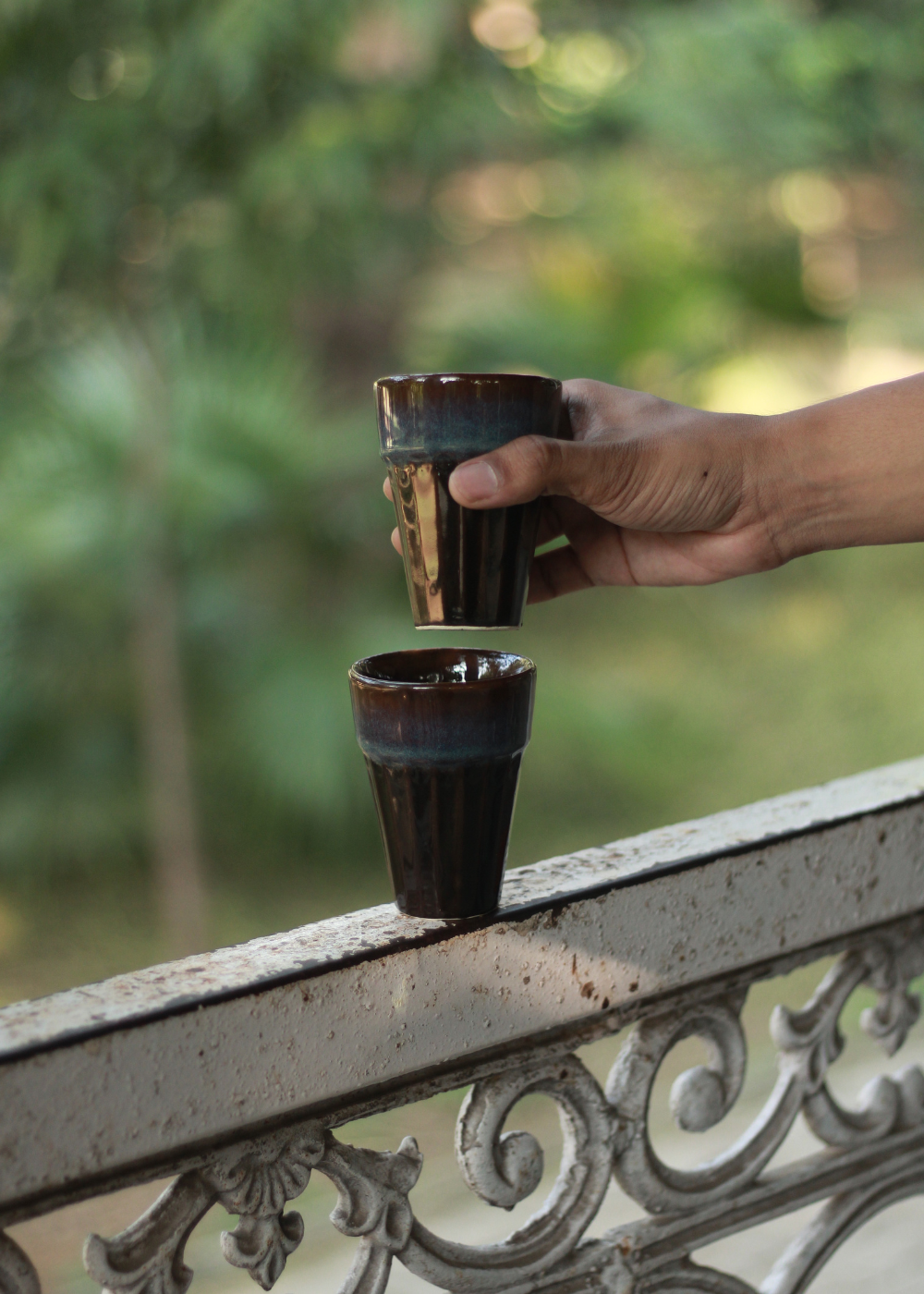 Brown tapri chai glass in hand 