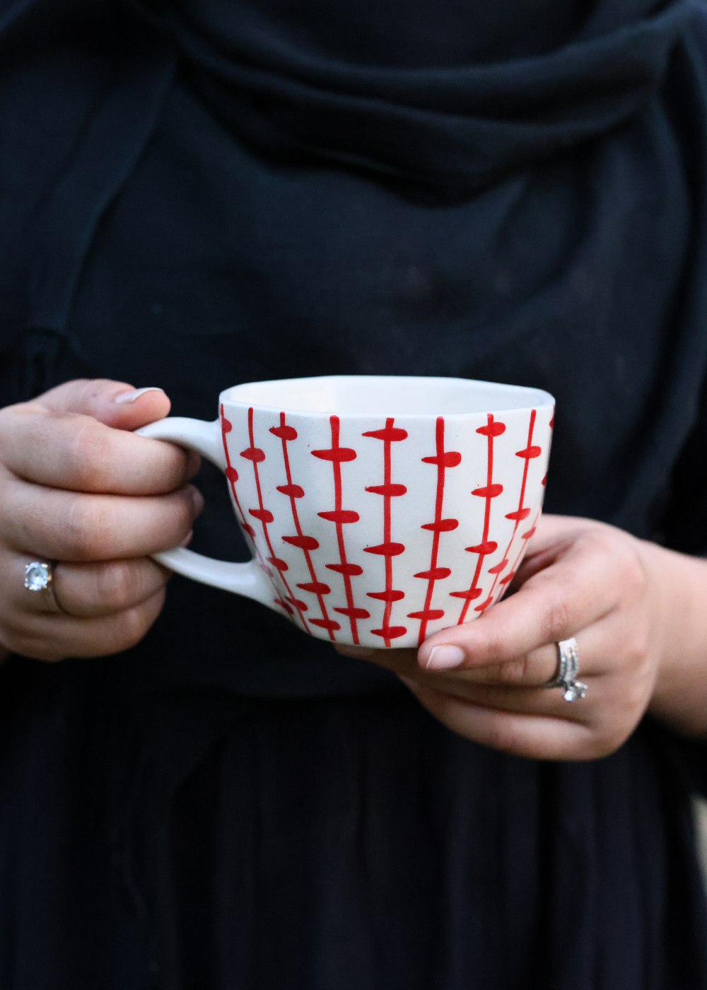 Red crosses mug in hand 