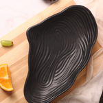 Black mistif bowl on a wooden surface
