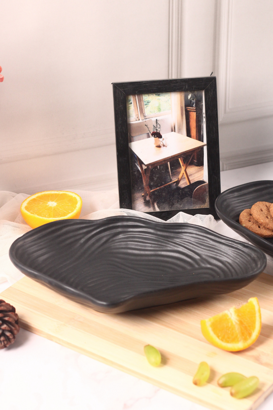 Black mistif bowl with fruits and cookies