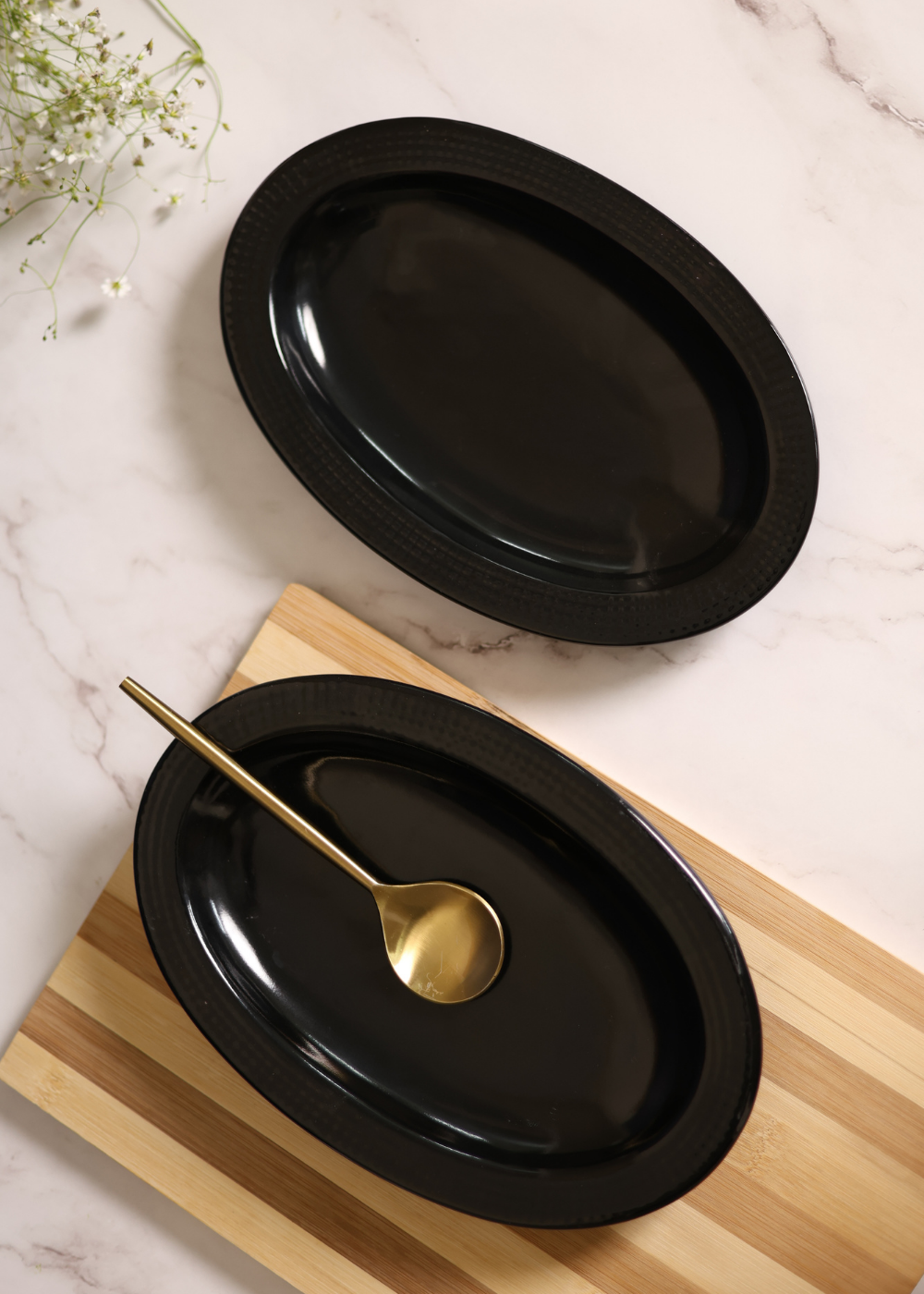 Two black oval bowl with spoon