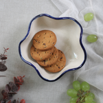 Handmade ceramic curvy bowl with cookies