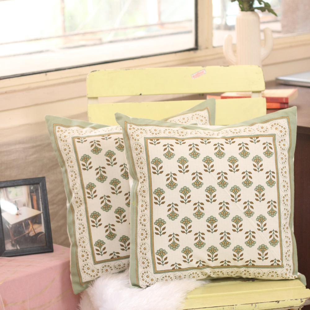 Green floral motifs cushion covers on chair