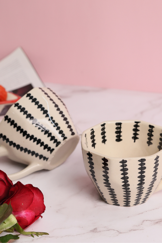 Two coffee mugs with roses and strawberries