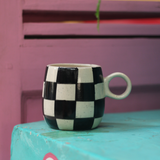Black & white chess mug on table