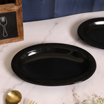 Black oval bowl on a white surface