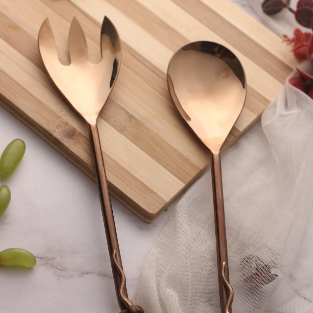 Bronze cutlery set on wooden surface