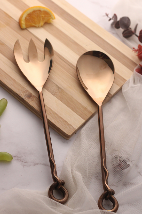 Bronze cutlery set on wooden surface
