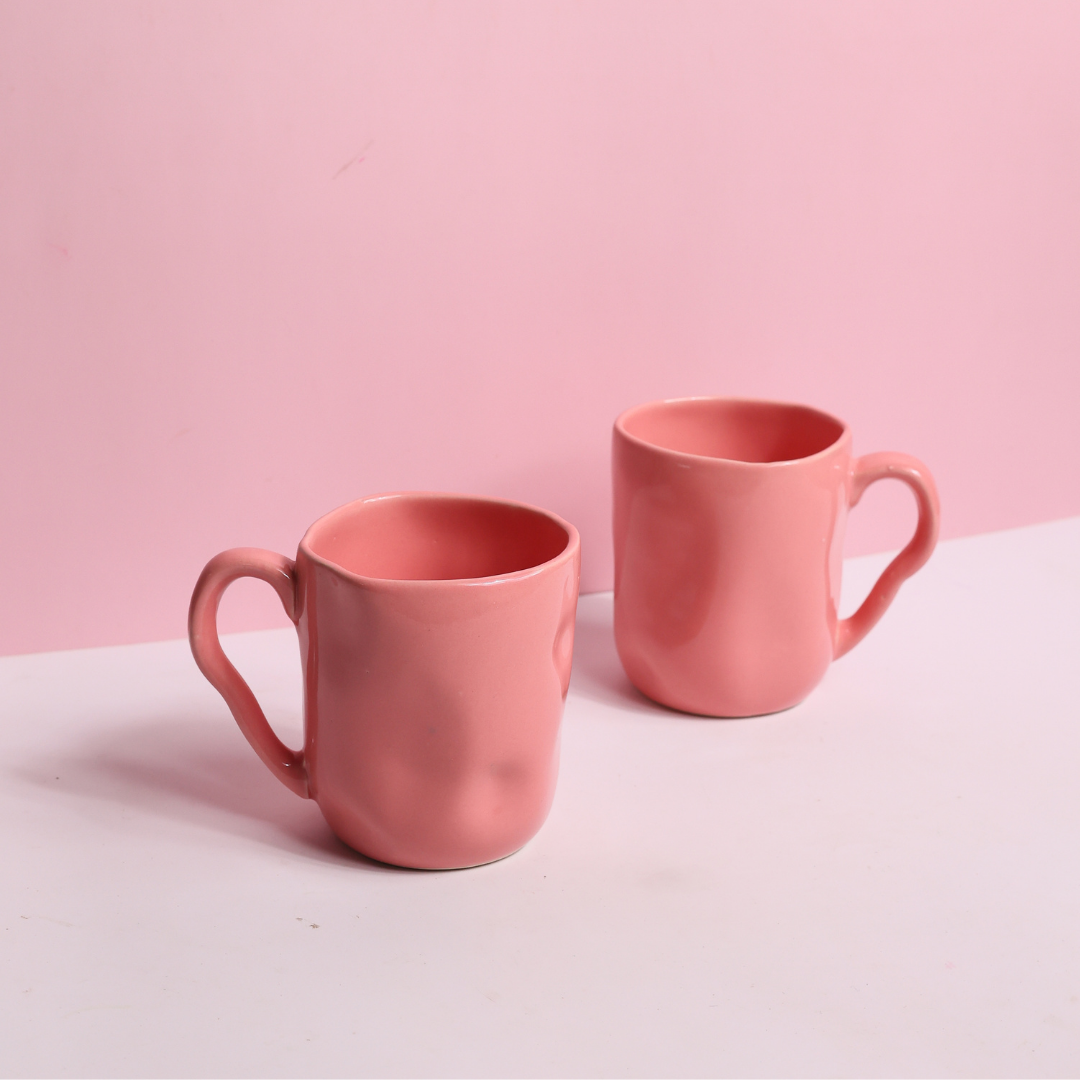 Two handmade pink wavy mugs 
