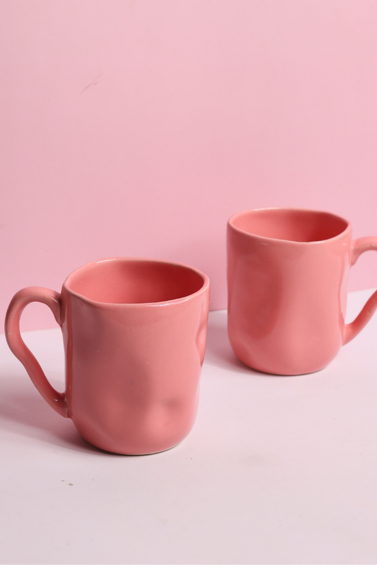 Two handmade pink wavy mugs 