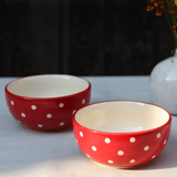 Red and white bowls on a white surface
