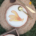 Banana plate on a mat with cutleries