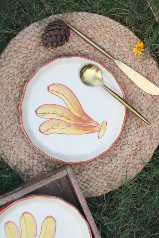 Banana plate on a mat with cutleries