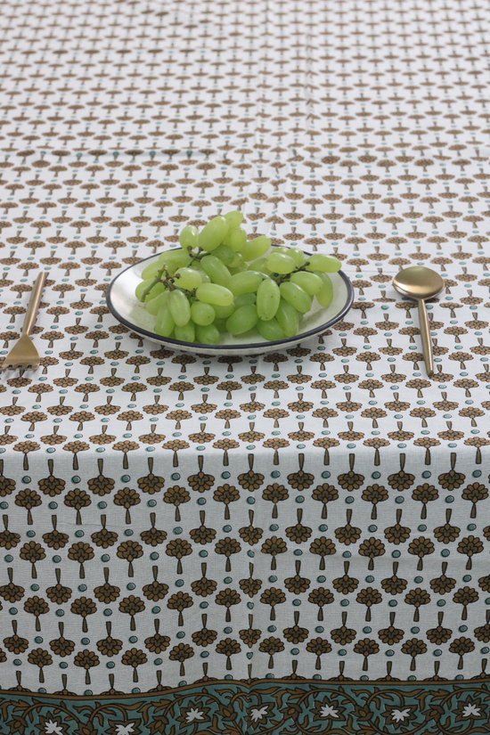 Floral table cloth with grapes and spoon