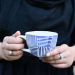 Blue lines coffee mug in hand