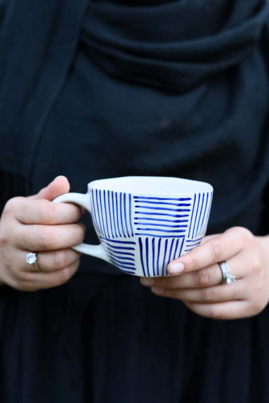 Blue lines coffee mug in hand