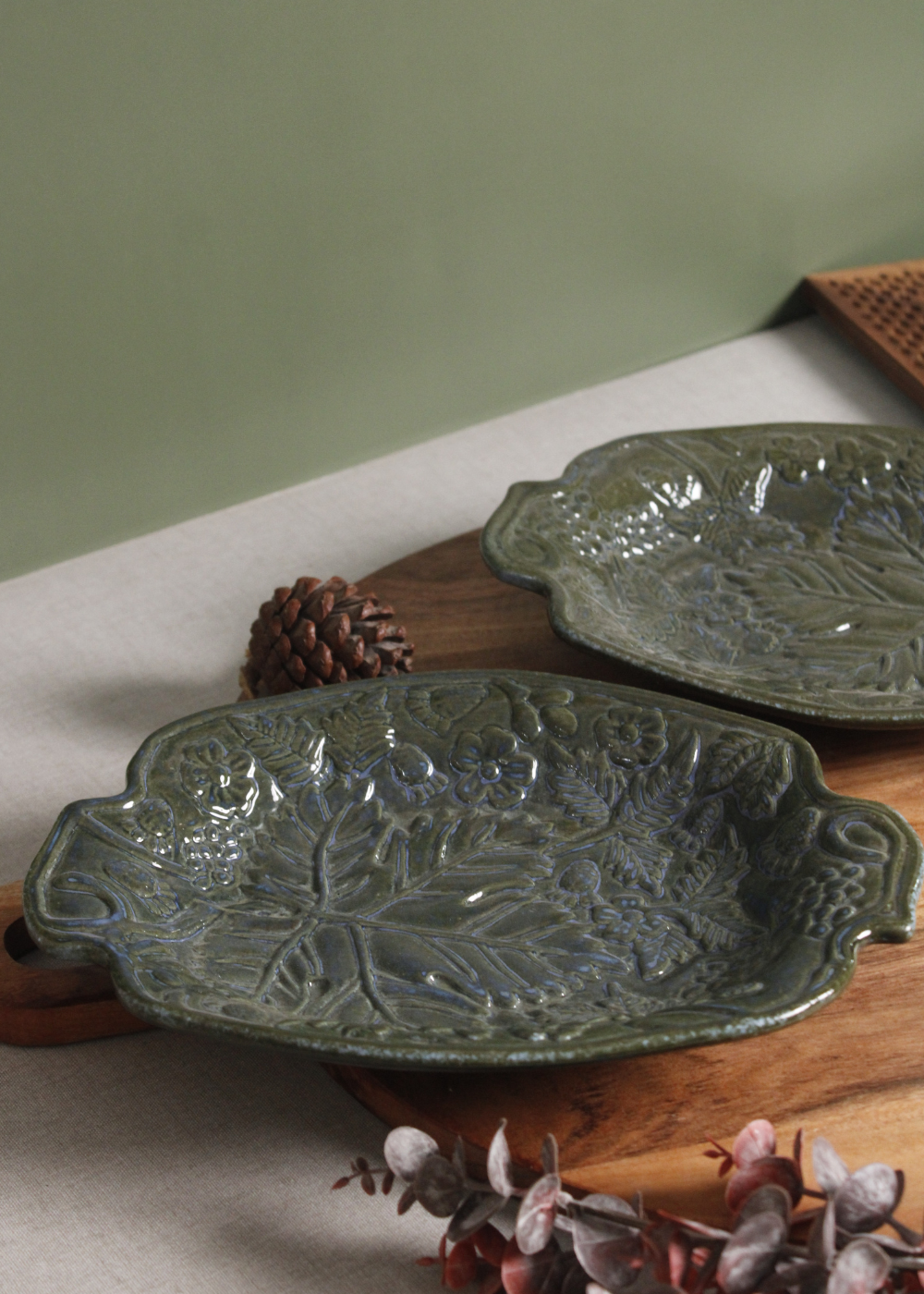 Ceramic green platter on wooden surface
