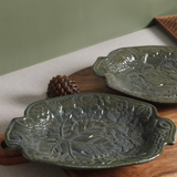 Ceramic green platter on wooden surface