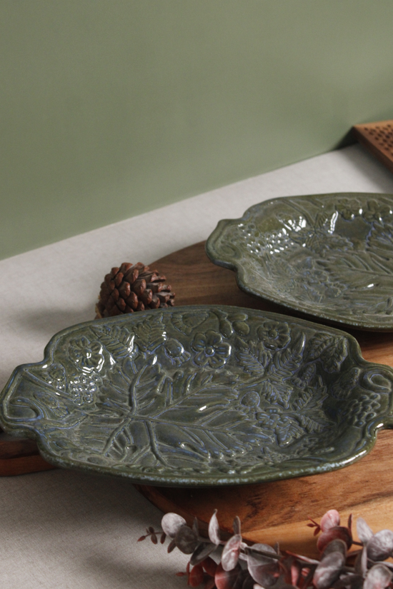 Ceramic green platter on wooden surface