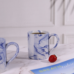 Handmade ceramic blue coffee mug with coffee
