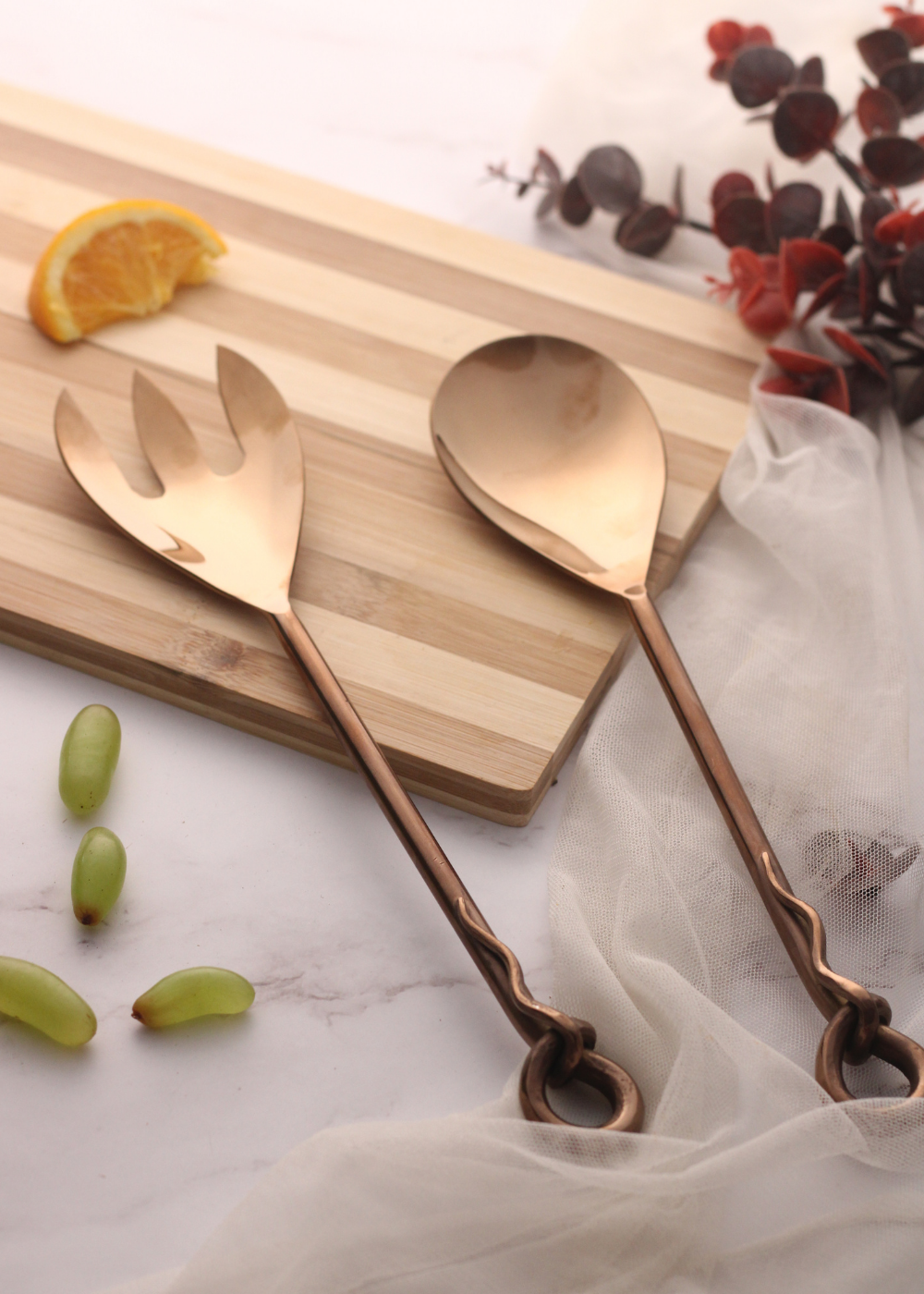 Bronze salad cutlery set on wooden surface