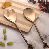 Bronze salad cutlery set on wooden surface