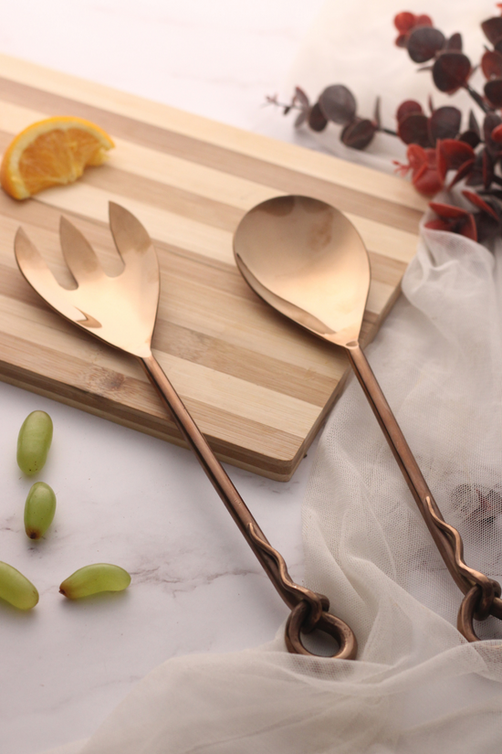 Bronze salad cutlery set on wooden surface