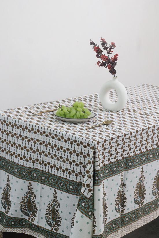 Green & brown floral table cloth with vase & fruits