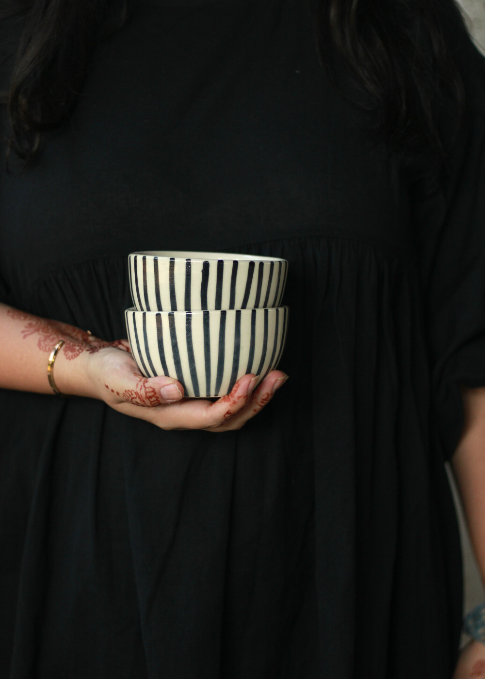 Black lined soup bowl in a hand