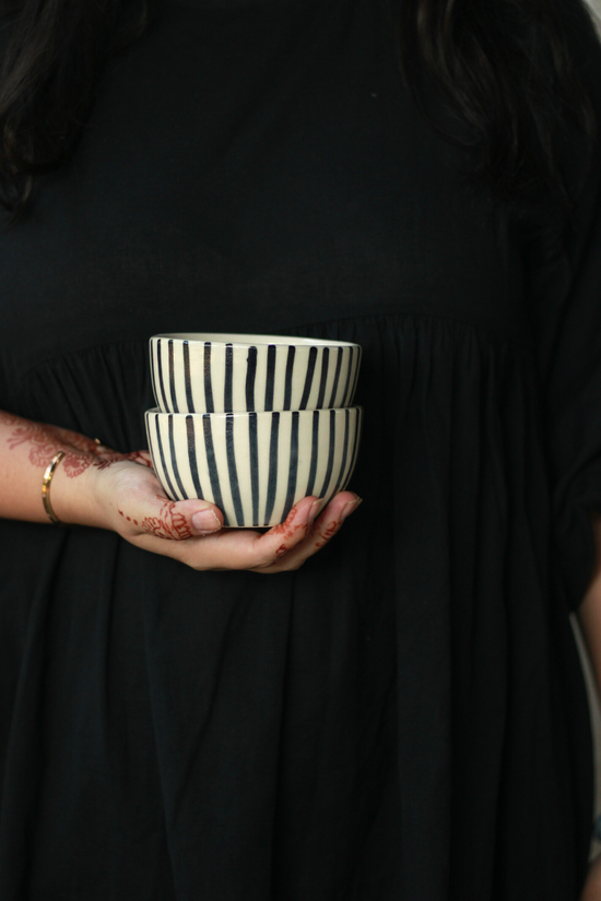 Black lined soup bowl in a hand
