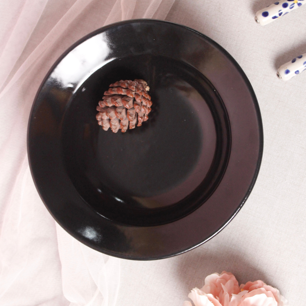 Black pasta plate with a flower
