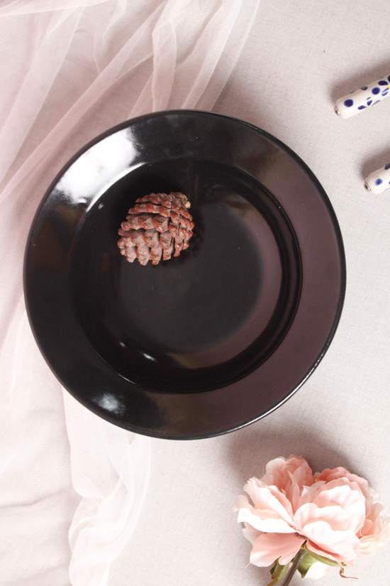 Black pasta plate with a flower