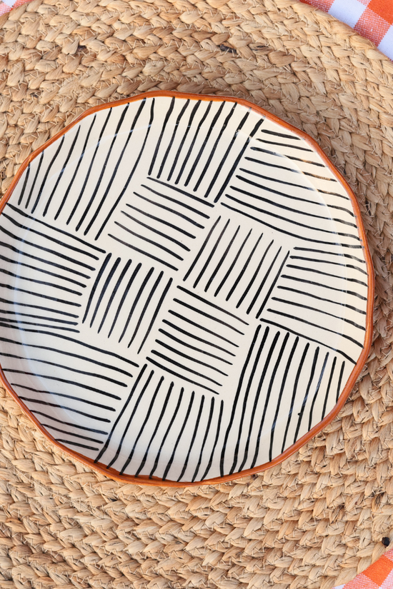 Black and white all lines plate and a strawberry