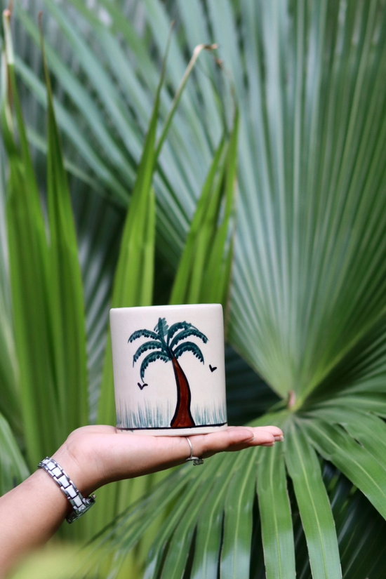 Palm tree brush holder in hand 
