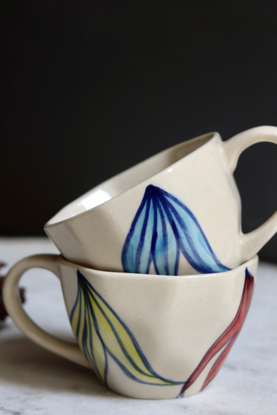 Two handmade ceramic petal coffee mugs