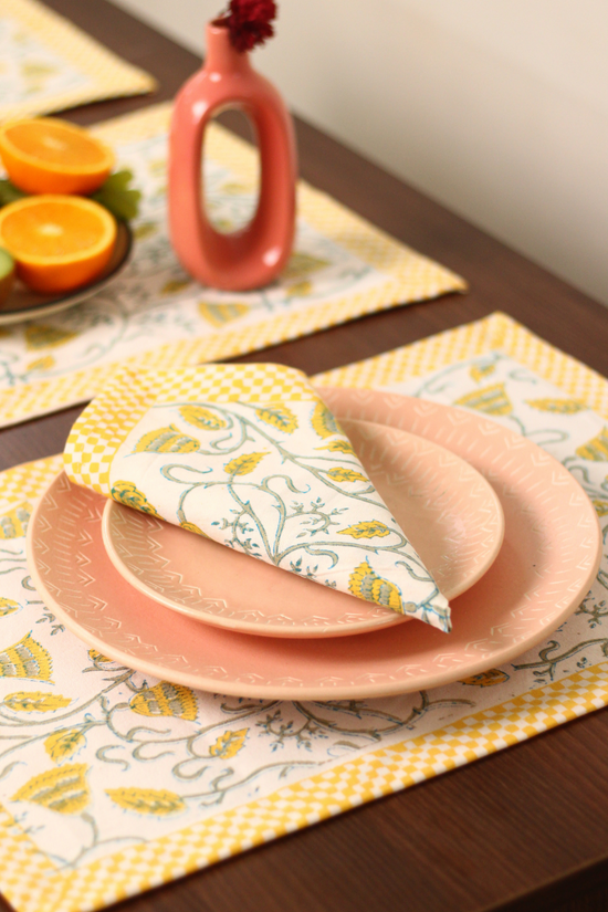 Yellow bail cotton table mat & napkin on table 