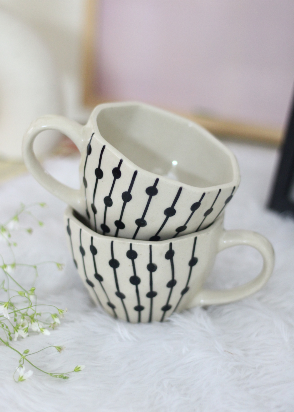 Handmade ceramic coffee mugs on each other