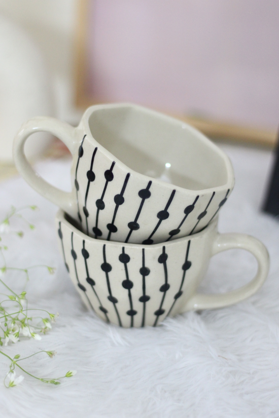 Handmade ceramic coffee mugs on each other