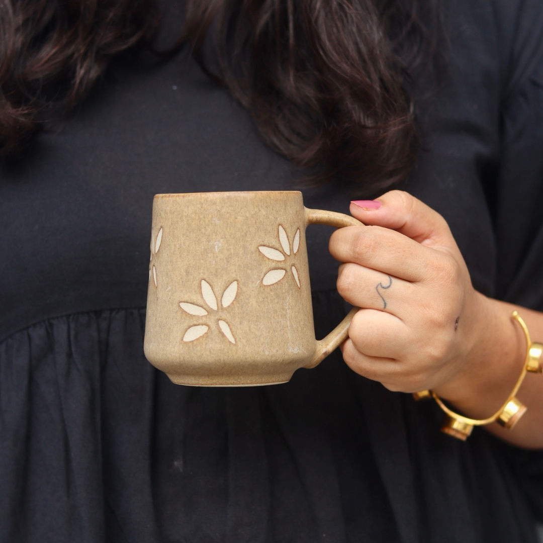 Brown leaf coffee mug in hand