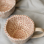 Top shot of red polka mugs