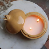 Handmade wax citrus anar candle with open lid 