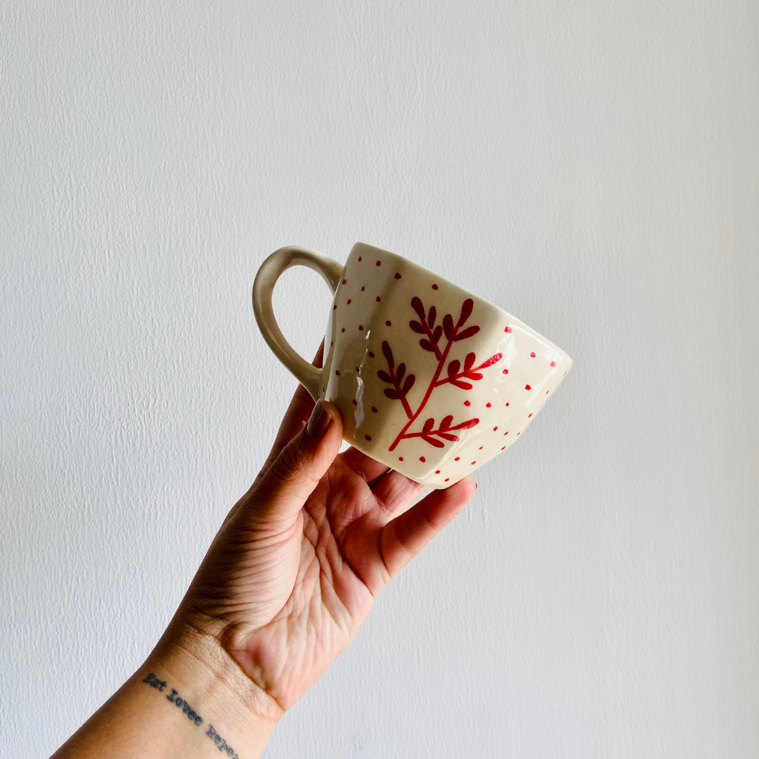 Red fall leaf mug in hand 