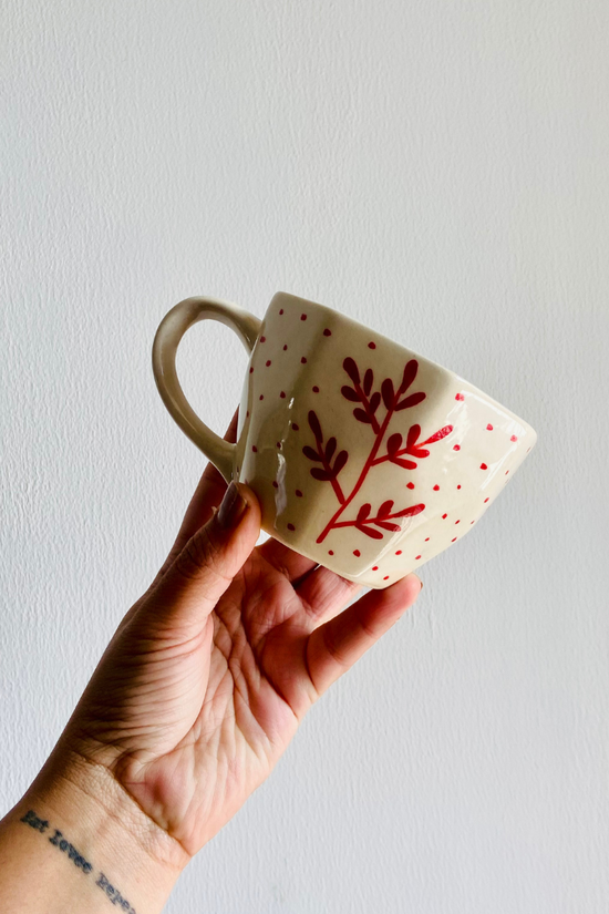 Red fall leaf mug in hand 