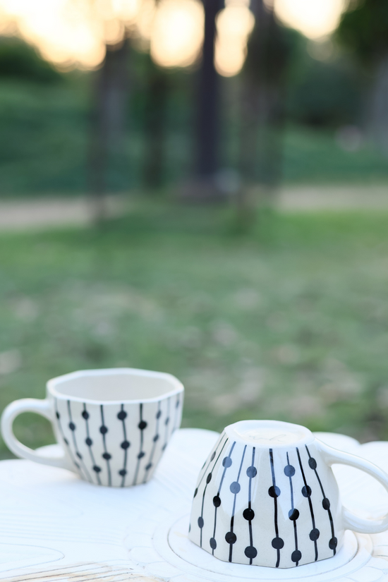 Black dotted ceramic mugs