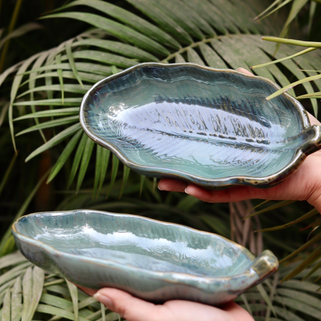 Two ceramic platters in hand 