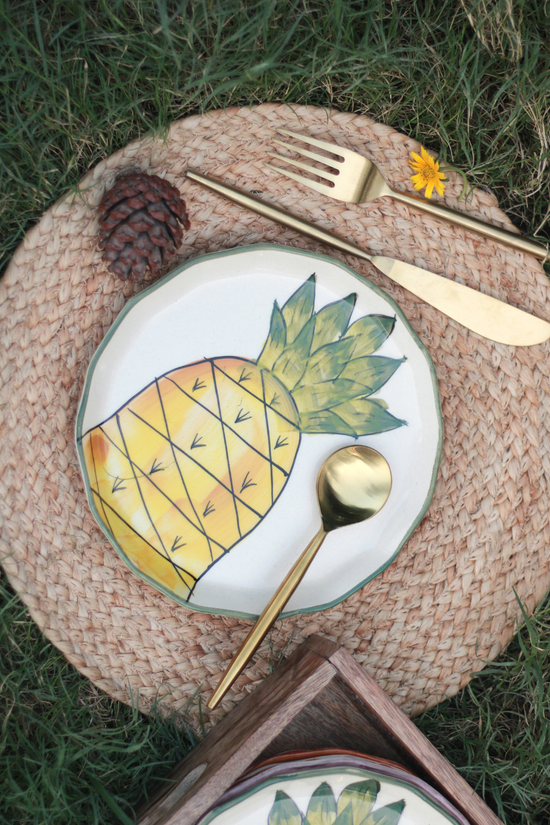 Ceramic pineapple plate on mat 