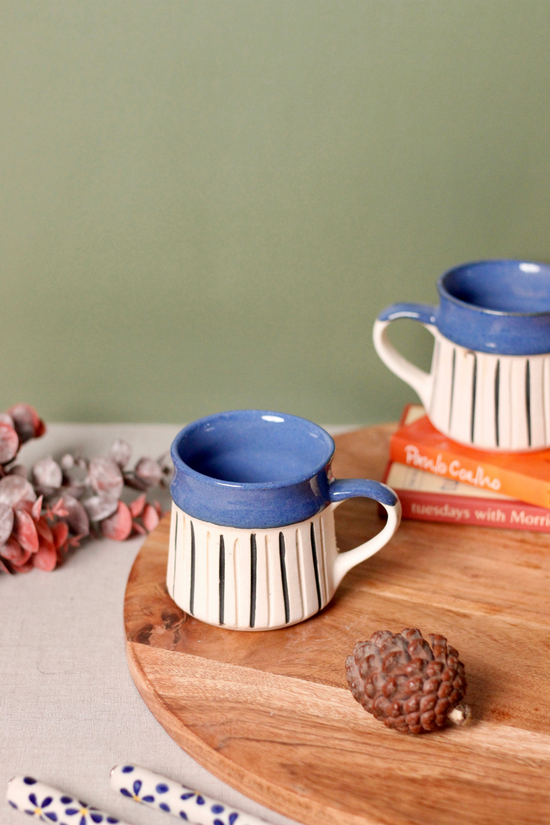 Glossy & matte blue mug on wooden surface